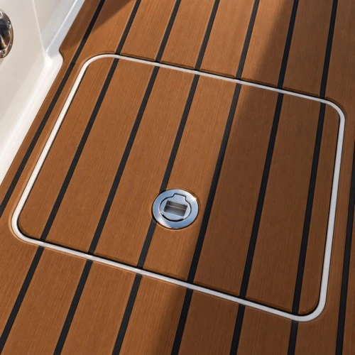 Boat deck hatch with teak-look foam flooring strips, black grooves, and round metal hardware.